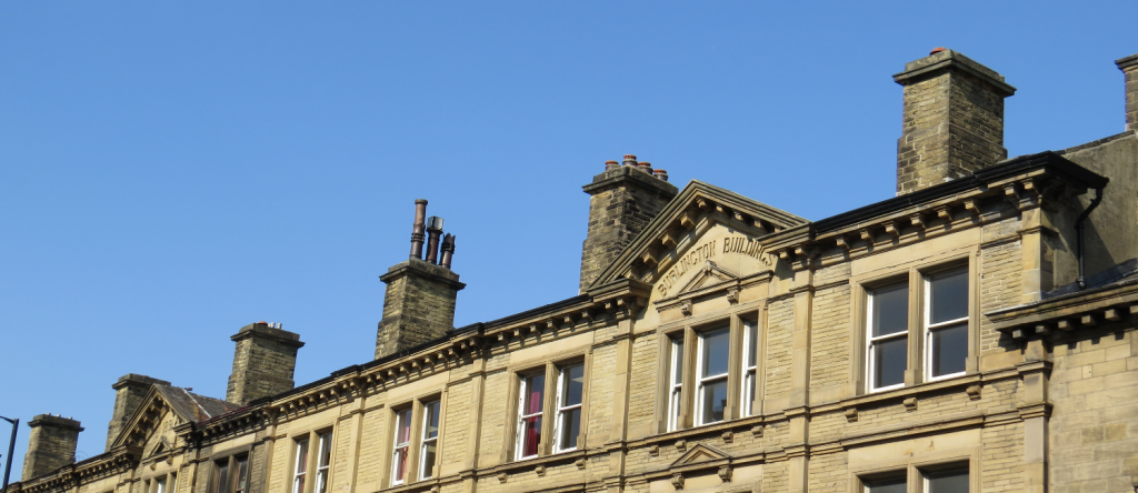 Some fancy looking buildings with a clear blue sky behind