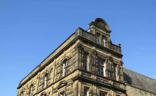 A yellow stone building against blue sky
